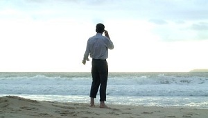 Man on the Beach for Retail Customers with Cell/Mobile Phone